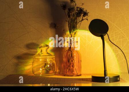 Sunset projector lamp on the table. Multi colored RGB light. Home decor. Copy space Stock Photo