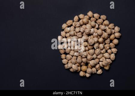 Raw chickpeas close-up on a black background. Isolated Stock Photo