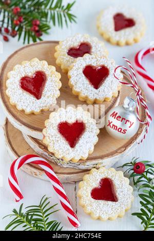 christmas bakery biscuits Spitzbuben on wooden disc Stock Photo