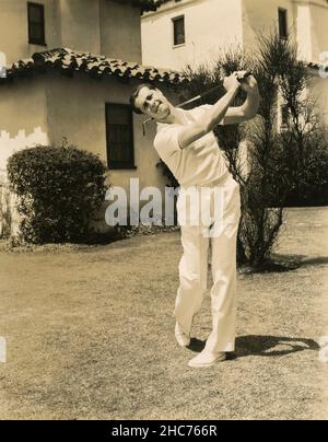 American actor Don Ameche playing golf, USA 1930s Stock Photo