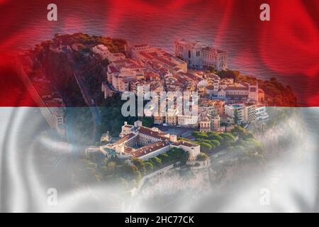 Monaco. Prince palace and old town on the rock in Monaco on Monegian flag overlay view. Principality of Monaco Stock Photo