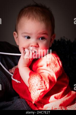 Baby girl in the light from the window Stock Photo