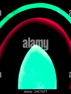 Colorful lights falling crookedly on the wall on a dark background Stock Photo