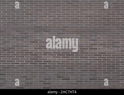 Dark brown bricks dirty wall background with little paint stains Stock Photo