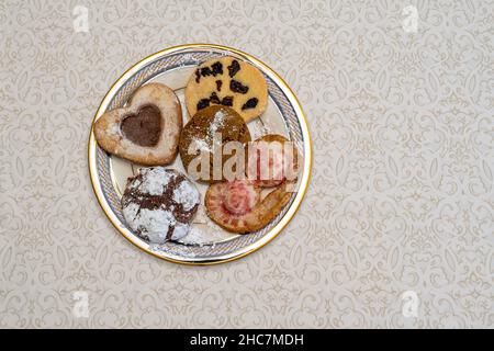 Cookies pastries on an elegant plate with subtle table cloth in background. Copy Space. Stock Photo