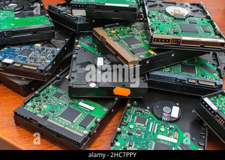 A pile of dusty broken and obsolete hard drives for disposal and recycling. Electronic data warehouse Stock Photo