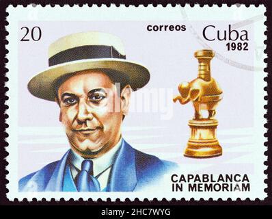 CUBA - CIRCA 1982: A stamp printed in Cuba issued for the 40th death anniversary shows World chess champion Jose Raul Capablanca and rook, circa 1982. Stock Photo