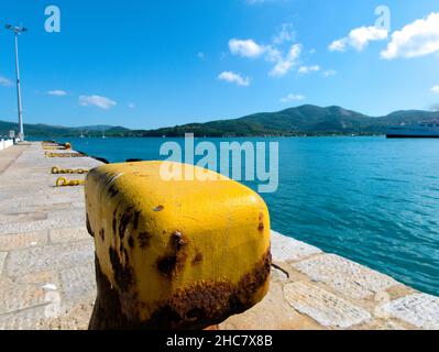 Close-up shot of a yellow top of a mooring bollard with some rusty spots Stock Photo