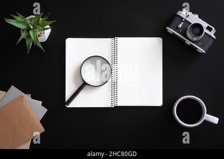 Open blank notebook on black background, flat lay. Stock Photo