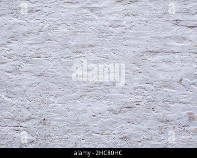 White textured stucco wall background. White stucco wall. Background of a white stucco coated and painted exterior, rough cast of cement and. White ba Stock Photo