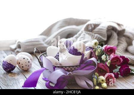 Easter composition with eggs, decorated with purple sparkles. Stock Photo