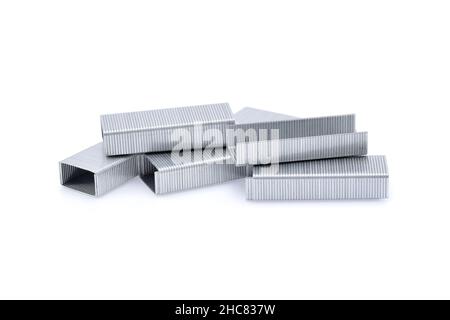 Stack of metal staples isolated on white background. Stock Photo