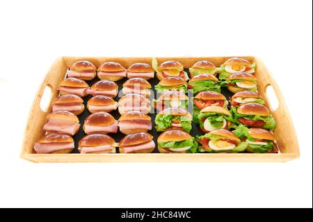Plate of vegetable bread roll with tomato, lettuce and egg and bread roll ham over white background Stock Photo