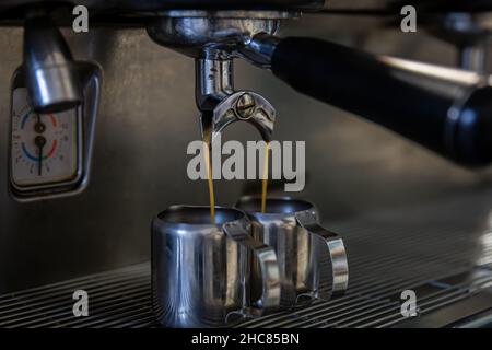 Close up of the process of making espresso in a professional coffee machine. Stock Photo