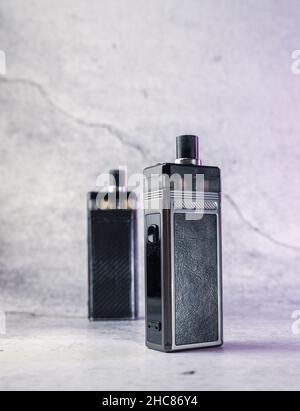 two vape electronic cigarettes on a gray background Stock Photo