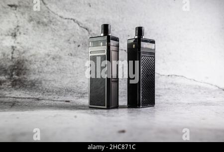 two vape electronic cigarettes on a gray background Stock Photo