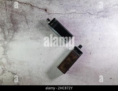 two vape electronic cigarettes on a gray background Stock Photo
