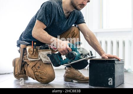 Circular Saw, carpenter using a circular saw for wood. Stock Photo