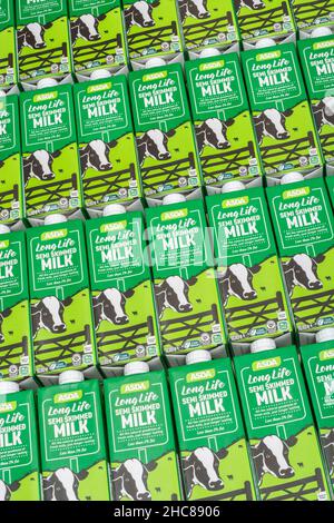 1 Litre paper carton units of ASDA own-label long-life UHT semi-skimmed milk. For British food produce, UK dairy industry, supply chain crisis UK. Stock Photo