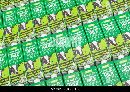 1 Litre paper carton units of ASDA own-label long-life UHT semi-skimmed milk. For British food produce, UK dairy industry, supply chain crisis UK. Stock Photo