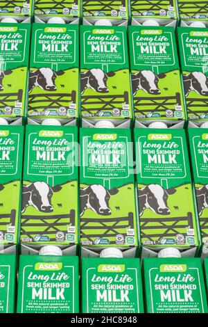 1 Litre paper carton units of ASDA own-label long-life UHT semi-skimmed milk. For British food produce, UK dairy industry, supply chain crisis UK. Stock Photo