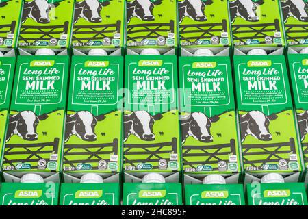 1 Litre paper carton units of ASDA own-label long-life UHT semi-skimmed milk. For British food produce, UK dairy industry, supply chain crisis UK. Stock Photo