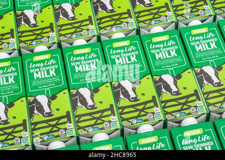 1 Litre paper carton units of ASDA own-label long-life UHT semi-skimmed milk. For British food produce, UK dairy industry, supply chain crisis UK. Stock Photo