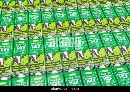 1 Litre paper carton units of ASDA own-label long-life UHT semi-skimmed milk. For British food produce, UK dairy industry, supply chain crisis UK. Stock Photo