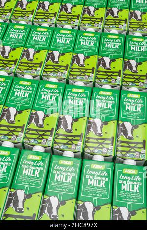 1 Litre paper carton units of ASDA own-label long-life UHT semi-skimmed milk. For British food produce, UK dairy industry, supply chain crisis UK. Stock Photo