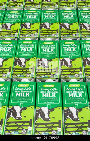 1 Litre paper carton units of ASDA own-label long-life UHT semi-skimmed milk. For British food produce, UK dairy industry, supply chain crisis UK. Stock Photo