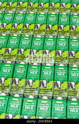 1 Litre paper carton units of ASDA own-label long-life UHT semi-skimmed milk. For British food produce, UK dairy industry, supply chain crisis UK. Stock Photo