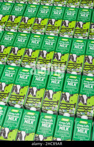 1 Litre paper carton units of ASDA own-label long-life UHT semi-skimmed milk. For British food produce, UK dairy industry, supply chain crisis UK. Stock Photo