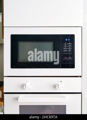 White microwave oven in modern scandi kitchen Stock Photo