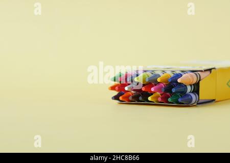 Color pencils on yellow papers on table  Stock Photo