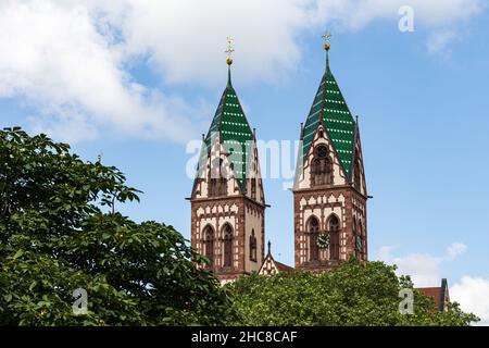 Twin towers of the Sacred Heart Church Herz-Jesu-Kirche in Freiburg im Breisgau, Baden-Wuerttemberg, Germany Stock Photo