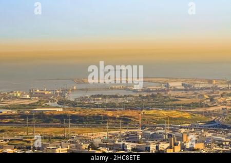 Haifa Bay covered in smoke and smog. The Inversion layer is visible. Haifa's industrial area is one of the largest sources of air pollution in the cou Stock Photo