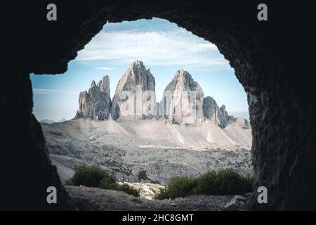 three peaks of lavaredo peaks as seen from inside a cave where soldiers use to sleep during the second or first world war Stock Photo