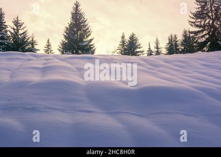 Fantastic winter landscape during sunset. colorful sky glowing by sunlight. Dramatic wintry scene. Stock Photo