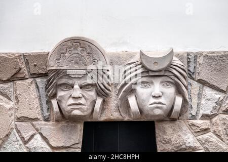 Relief of an Inca man and woman on a building wall in San Blas, Cusco, Sacred Valley, Peru Stock Photo