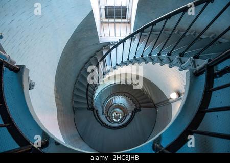 Looking down circular staircase inside historic lighthouse Stock Photo