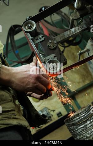 knife sharpening machine and master. Grinding machine. grinding knife using  abrasive stone Stock Photo - Alamy