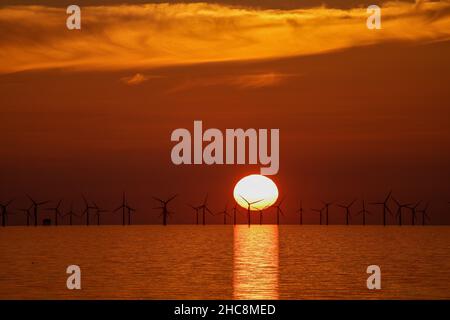 Sunset over the Gwynt-y-Môr offshore wind farm, Colwyn Bay, North Wales Stock Photo