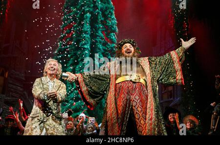 l-r: Tommy Steele (Ebenezer Scrooge), James Head (Ghost of Christmas Present) in SCROOGE at the London Palladium, London W1  06/11/2012  based on 'A Christmas Carol' by Charles Dickens  book, music & lyrics: Leslie Bricusse  design: Paul Farnsworth  lighting: Nick Richings  choreography: Lisa Kent  illusions: Paul Kieve  director: Bob Tomson Stock Photo