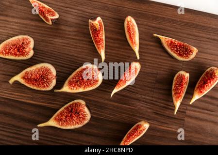 Ripe fresh figs sliced on wooden kitchen board. Top view Stock Photo