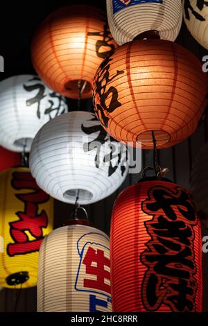 Chinese paper lanterns lamps in stylish cafe. China restaurant decorations for interior design Stock Photo