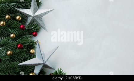 Christmas decorations, pine tree leaves, balls, berries on snow white background, Christmas concept Stock Photo