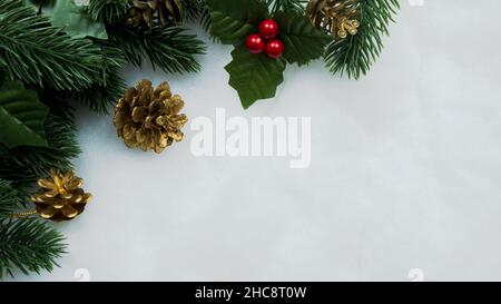 Christmas decorations, pine tree leaves, balls, berries on snow white background, Christmas concept Stock Photo