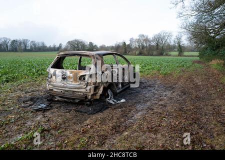 Burnt Out Volkswagen Golf GTi Car in Field Stock Photo