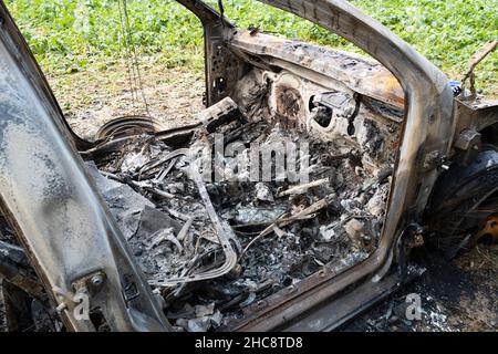 Burnt Out Volkswagen Golf GTi Car in Field Stock Photo