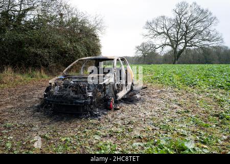 Burnt Out Volkswagen Golf GTi Car in Field Stock Photo